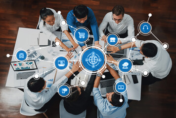 A diverse team engages in a collaborative business strategy session, emphasizing technology and global connectivity, surrounded by digital icons and data analytics tools. Amity