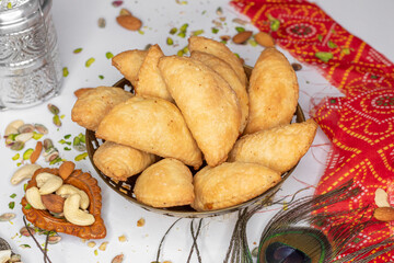 Gujhiya, Indian fried sweet with dry fruits and fancy decorative background