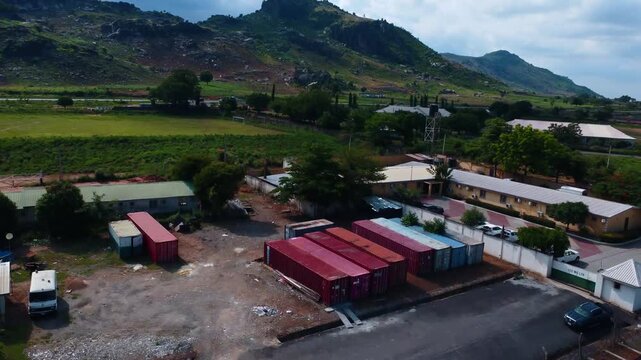 Establishing shot of SCC engineering site with rural landscape and cloudy sky. A construction company in Abuja, Nigeria.