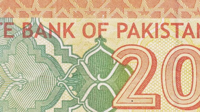 Close-up pan along a 20 rupee note, revealing "State Bank of Pakistan" text and security guilloche