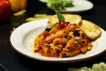 Pasta with tomato sauce and basil leaf garlic bread 