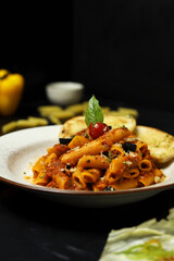 Pasta with tomato sauce and basil leaf garlic bread 