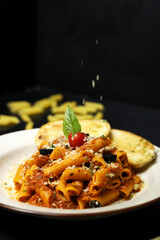 Pasta with tomato sauce and basil leaf garlic bread 
