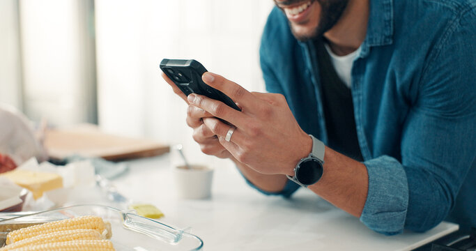 Phone, food and hands of man in kitchen for cooking with online recipe on mobile app in apartment. Happy, cellphone and person with ingredients for dinner, meal or supper with instructions in home.