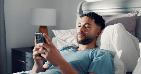 Man, phone and relax in bed for communication, social media or reading ebook on weekend at home....