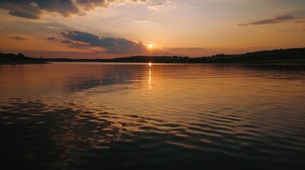 Obraz premium Sunset Reflection on a Calm Lake with Distant Hills