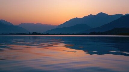 Fototapeta premium Sunset Reflection on a Calm Lake with Distant Hills