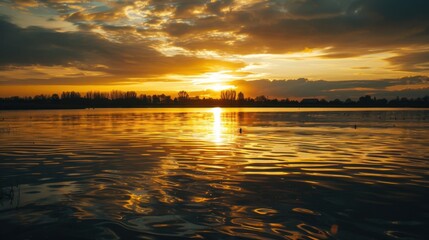 Obraz premium Sunset Reflection on a Calm Lake with Distant Hills