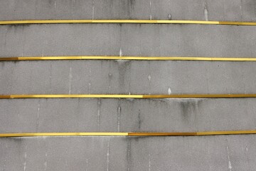 Concrete wall with gold metallic line decor pattern background