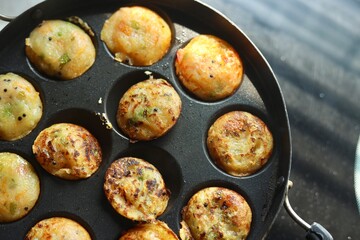 Appam or Mixed dal or Rava Appe South Indian dish preparation on iron pan