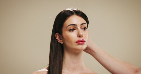 Woman, beauty and hands with hair for salon treatment, styling or cosmetics on a studio background....