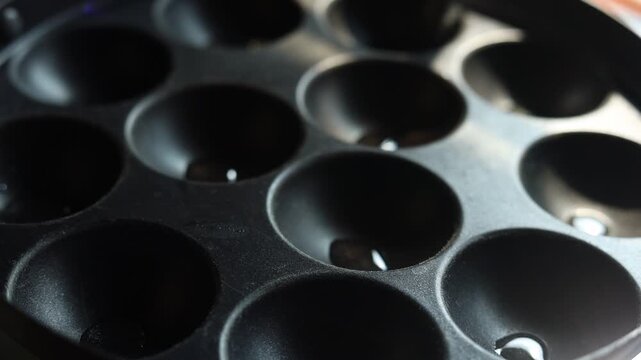 Appam or Mixed dal or Rava Appe South Indian dish preparation on iron pan