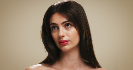 Naklejka premium Makeup, skincare and thinking with woman on studio background for cosmetic ideas or vision. Beauty, foundation and glow with female model on space for facial results, lipstick color or wellness
