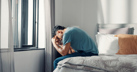 Obraz premium Frustrated, man and stress on bed at house with insomnia, sleeping disorder and depression. Tired, male person and mourning loss with mental health crisis, loneliness and emotional burnout in bedroom
