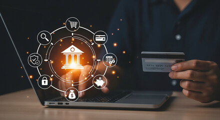 Person holding credit card with laptop and digital banking icons overlayed on the screen glow effect