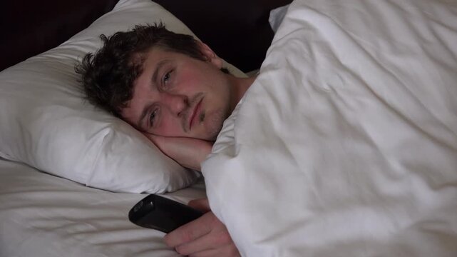 Tired man turns off tv and goes to sleep 4k