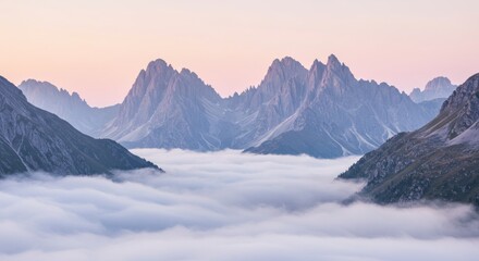 Jagged mountains peak above a sea of clouds under a pastel sky at dusk