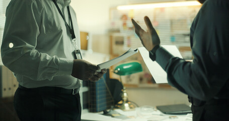 Document, hands or detective in office for collaboration, case briefing or discussion. Police...