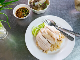 Hainanese Chicken Rice Served on Table in Restaurant. Asian Traditional Food.