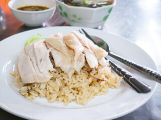 Hainanese Chicken Rice Served on Table in Restaurant. Asian Traditional Food.