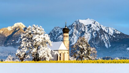 Snowy landscape with church and mountains