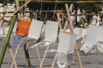 Traditional handmade paper lanterns made from saa paper hanging on bamboo frame displayed outdoor, Local thai handicraft decoration used for decorating loi krathong festival. close up	