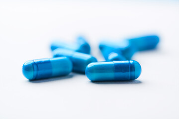 Amino acids capsules on bright background. Soft focus. Close up. Copy space.	