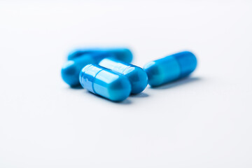 Amino acids capsules on bright background. Soft focus. Close up. Copy space.	