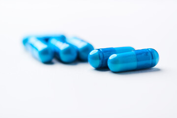 Amino acids capsules on bright background. Soft focus. Close up. Copy space.	