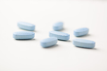 Multivitamin tablets on bright paper background. Close up. Copy space	