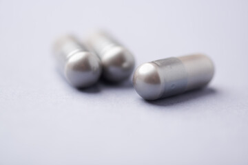 Amino acids capsules on bright background. Soft focus. Close up. Copy space.	