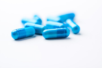 Amino acids capsules on bright background. Soft focus. Close up. Copy space.	