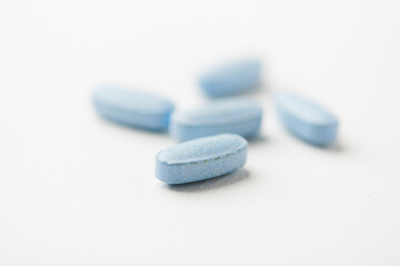 Multivitamin tablets on bright paper background. Close up. Copy space	