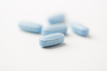 Multivitamin tablets on bright paper background. Close up. Copy space	
