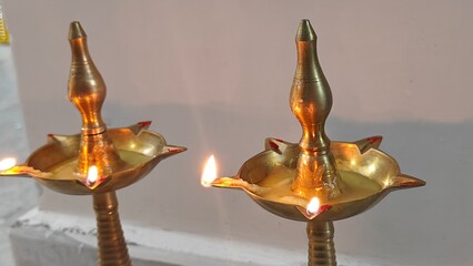 two Indian traditional brass diya oil lamps isolated on White Background