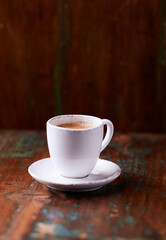 Cup of coffee on wooden background. Soft focus. Copy space	