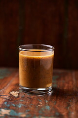 Mango smoothie on wooden background. Soft focus. Copy space.	