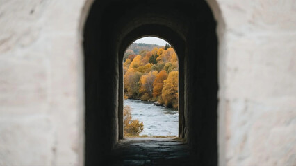 Fototapeta premium Autumn River Landscape Viewed Through a Dark Archway