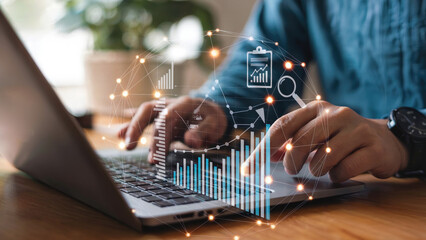 Businessman analyzing financial data on laptop with digital interface, business growth concept