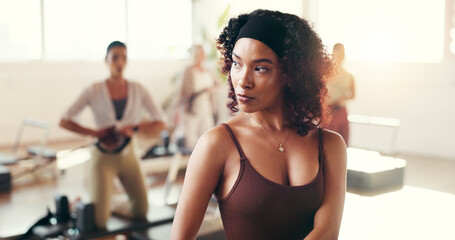 Fitness, pilates class and woman for wellness, gym and workout with balance on reformer. Health, hobby and female person on machine for core strength, exercise or training activity in yoga studio.