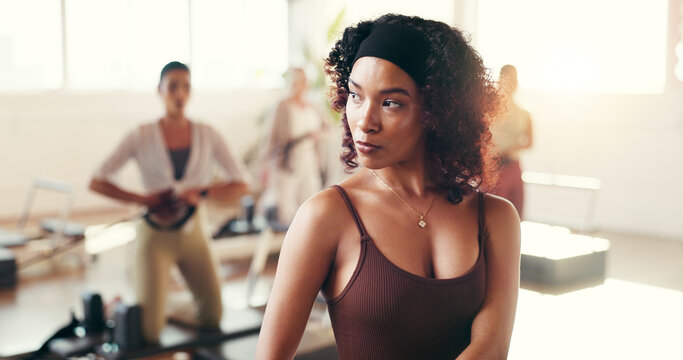 Fitness, pilates class and woman for wellness, gym and workout with balance on reformer. Health, hobby and female person on machine for core strength, exercise or training activity in yoga studio.