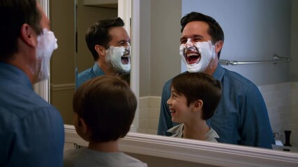 Father and son sharing a playful moment while shaving in bathroom - Powered by Adobe