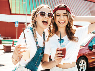 Two young beautiful smiling hipster female in trendy summer clothes.Sexy carefree women posing...