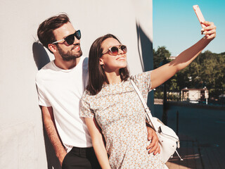Smiling beautiful woman and her handsome boyfriend. Woman in casual summer clothes. Happy cheerful...