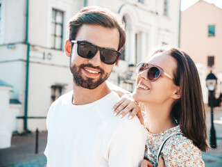 Smiling beautiful woman and her handsome boyfriend. Woman in casual summer clothes. Happy cheerful...