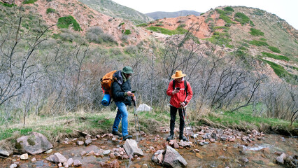 Two tourists have taken out their phones and are checking the map to see if they are following the...