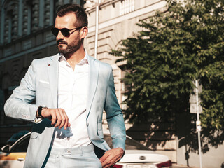 Portrait of handsome confident stylish hipster lambersexual model.Modern man dressed in elegant...