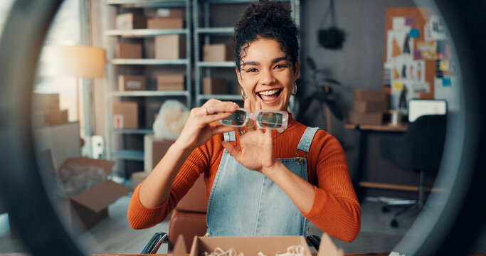Logistics, portrait and sunglasses with woman in office for advertising or product review. Boxes, ring light and supply chain with pov of employee at desk for delivery, ecommerce or shipping