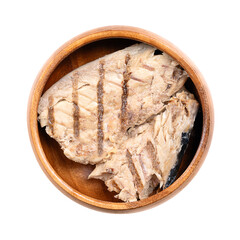 Grilled mackerel fillet, in its own juice, in a wooden bowl. Salted piece of mackerel, fried on a...