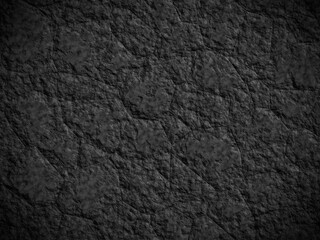 Smooth black rock surface with intricate patterns, ideal for abstract texture backgrounds.